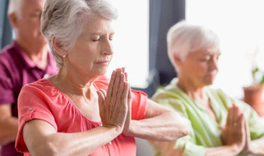 Senior benefitting from practicing yoga outside